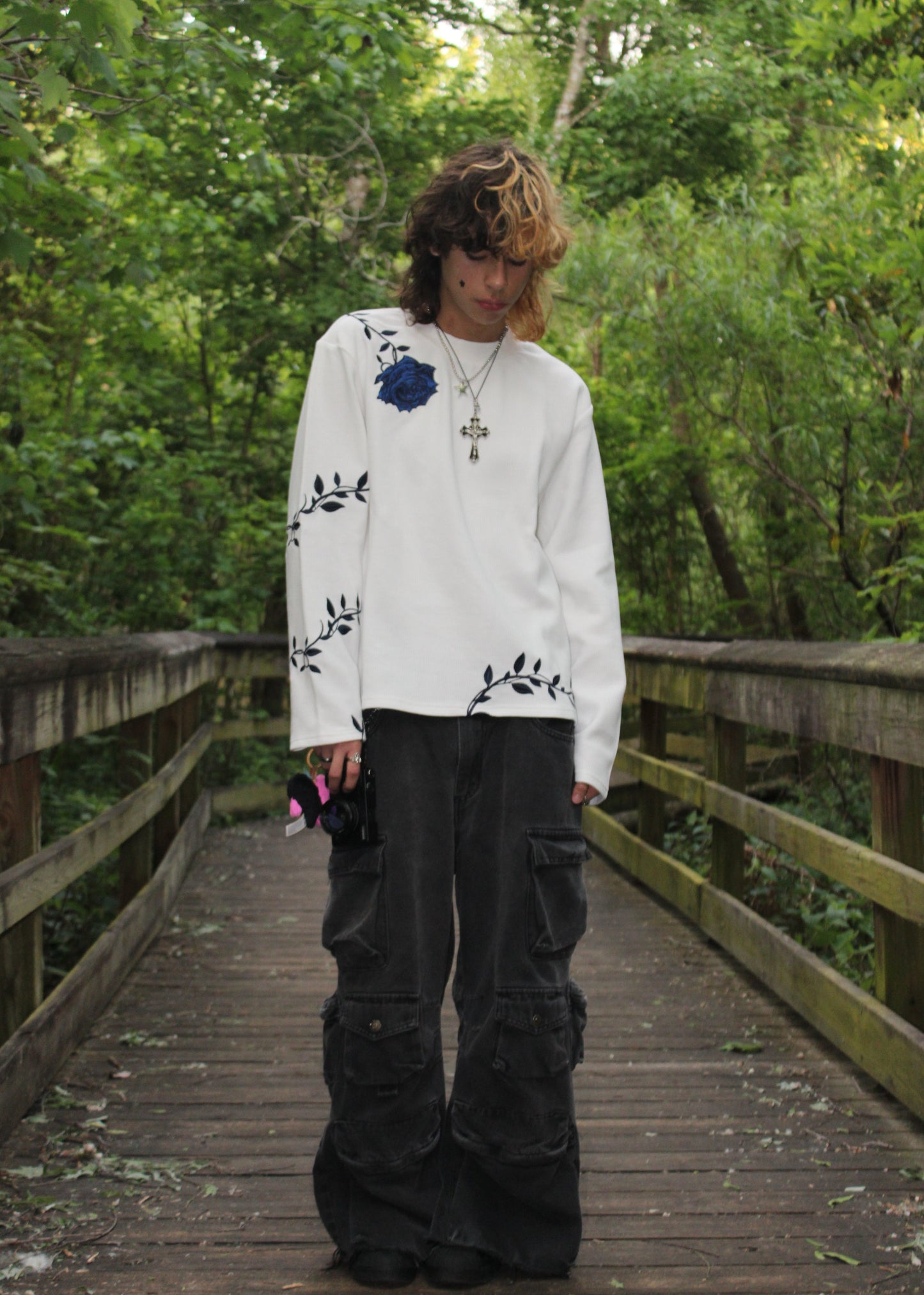 "GENESIS" long-sleeve thermal in white, worn with black cargo jeans — front view outdoors