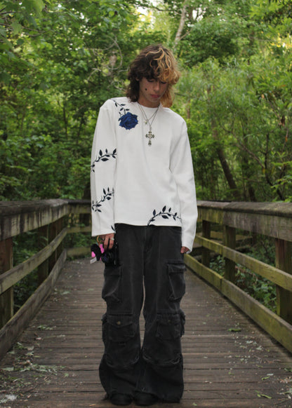 "GENESIS" long-sleeve thermal in white, worn with black cargo jeans — front view outdoors