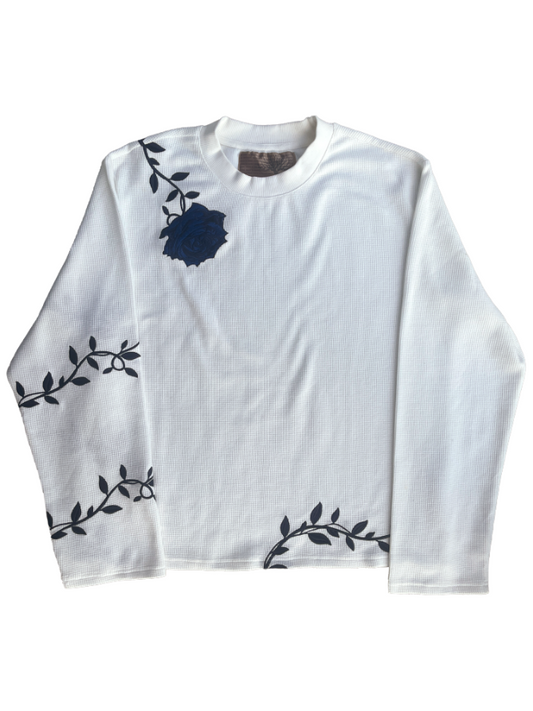 "GENESIS" long-sleeve thermal in white — flat lay showing navy rose embroidery and vine details